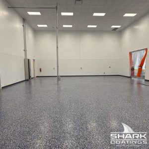Warehouse floor coated with Shark Coatings featuring a durable decorative flake floor coating.
